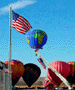 This print shows the balloon that carried the olympic torch as it was carried around the United States. The U.S. flag waves at the balloon from the 11 oclock and 5 o'clock positions.